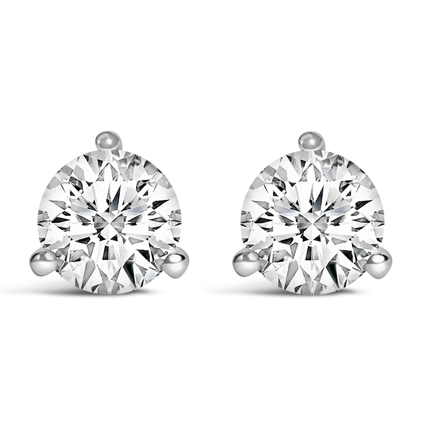 Front view of a pair of white metal stud earrings, each set with a round white gemstone in a three-prong setting.