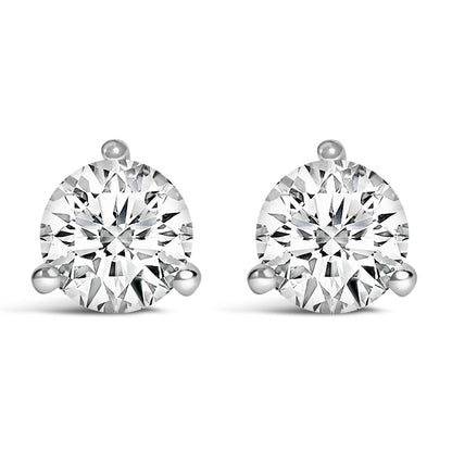 Close-up front view of a pair of white metal stud earrings featuring round white gemstones set in three-prong settings.