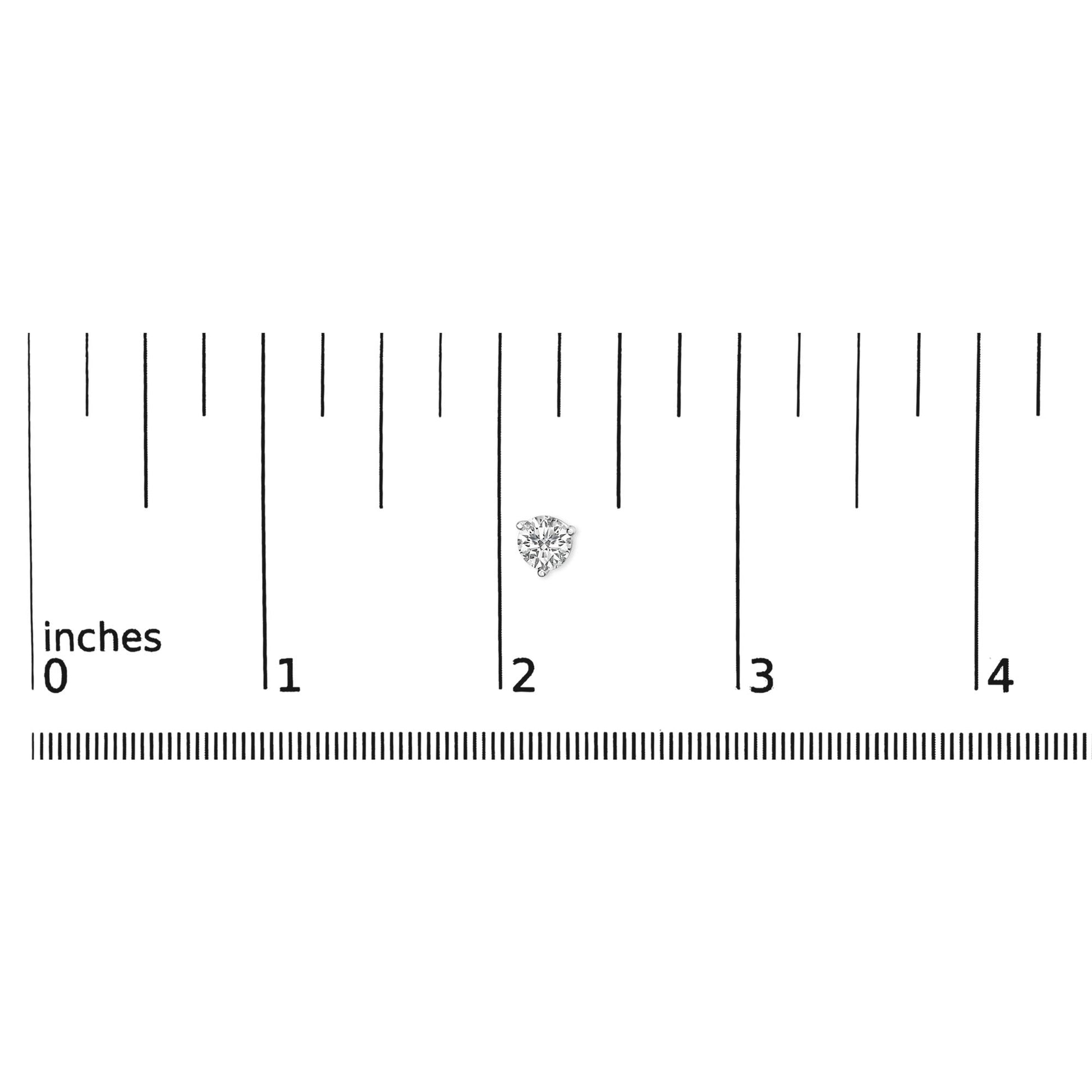 Close-up of a single white metal earring with a round white gemstone in a 3-prong setting, placed on a ruler for size reference.