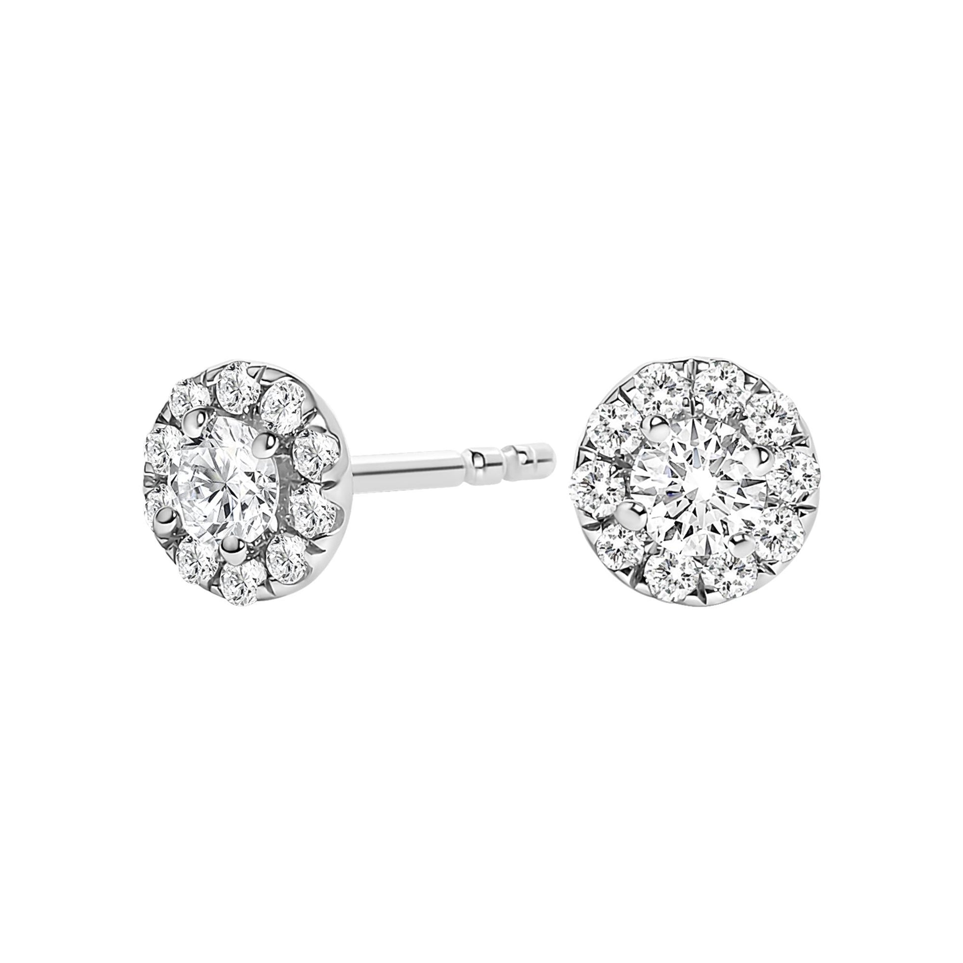 Close-up front and side angle of white metal stud earrings with a larger round white gemstone center surrounded by smaller round white gemstones in prong settings.