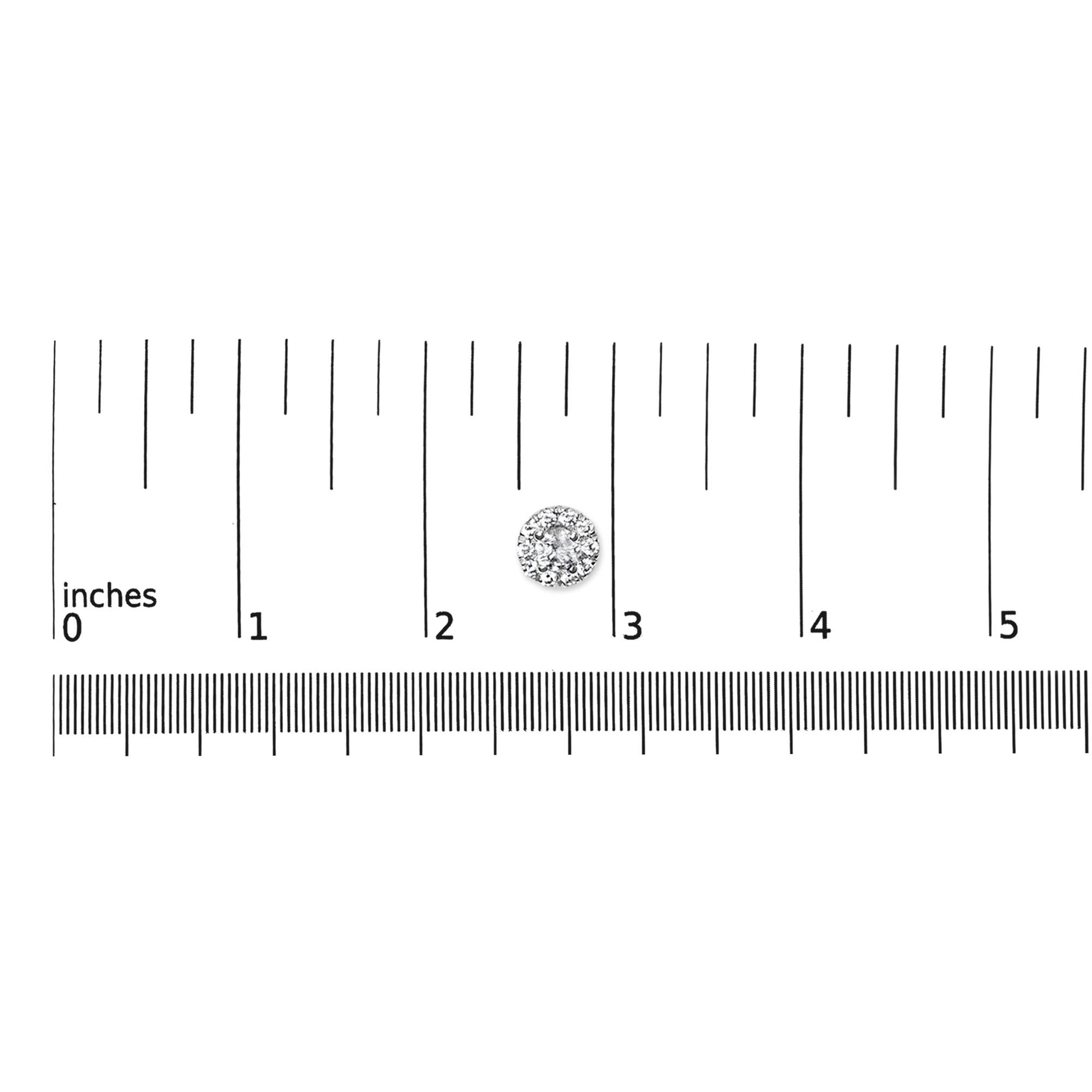 Single round white gemstone cluster earring in white metal, shown on a ruler for size reference, top-down view.