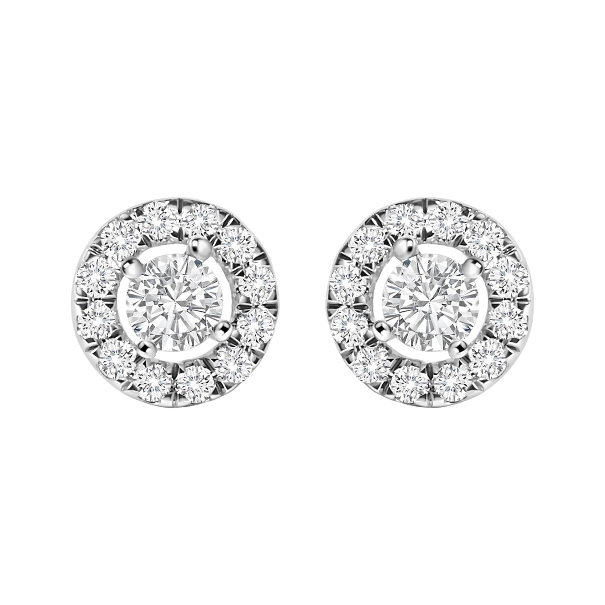 Front view of white metal round stud earrings featuring a central round white gemstone surrounded by smaller round white gemstones in a halo design.