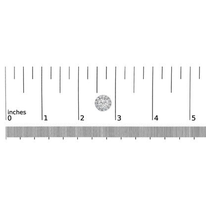 Close-up top view of a single white metal round earring with a central white gemstone surrounded by smaller white gemstones, placed on a ruler for size reference.