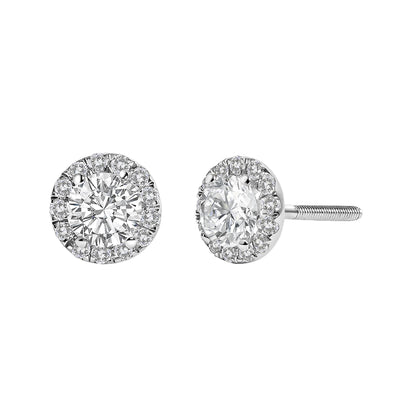 Front and side angled view of a pair of white metal stud earrings with a large round white gemstone center surrounded by smaller round white gemstones in prong settings.