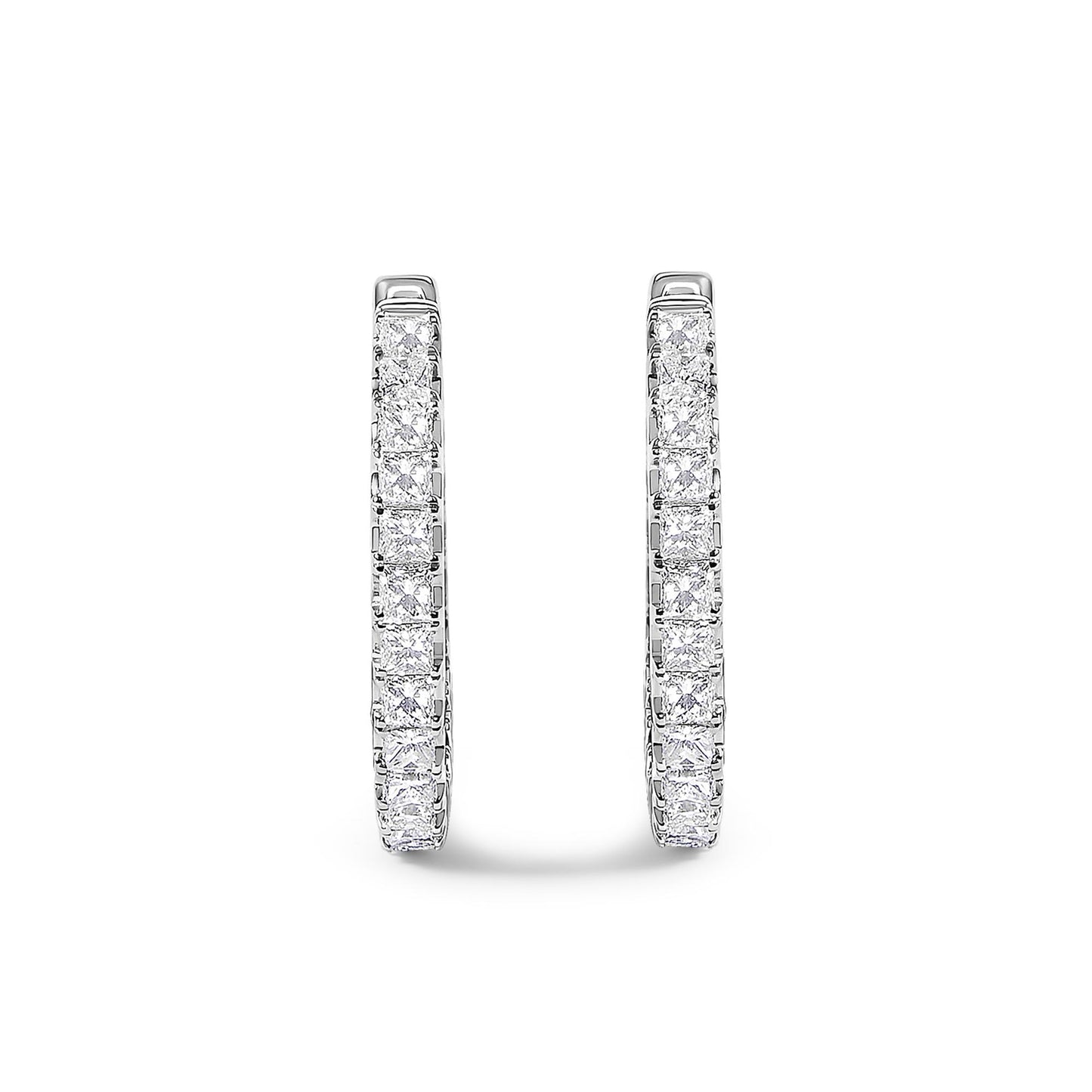 Close-up front view of a pair of white metal hoop earrings set with rows of princess-shaped white gemstones in prong settings.
