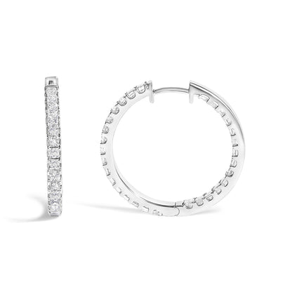 Close-up front and side angle of a pair of white metal hoop earrings set with multiple princess-shaped white gemstones in prong setting.