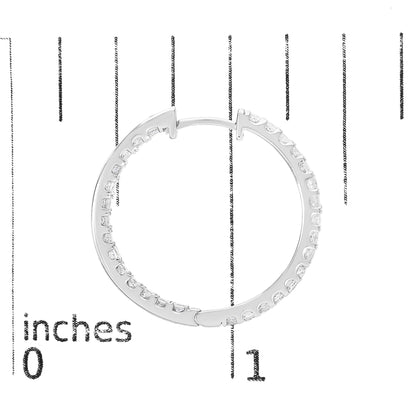 Close-up front angle of a white circular earring with princess-shaped white gemstones set in prong settings, shown on a scale.