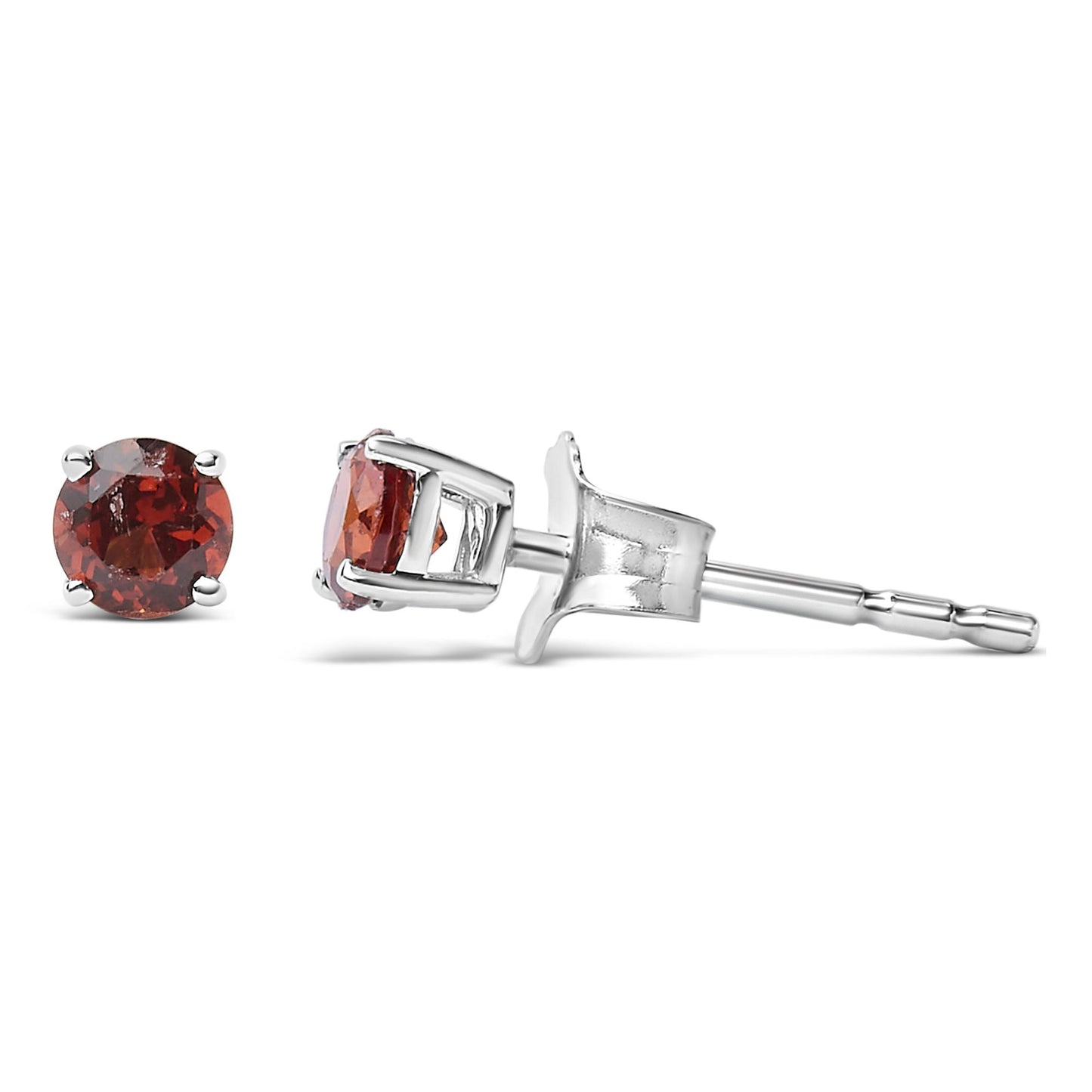 Close-up side angle of white metal stud earrings with round red gemstones in four-prong settings.