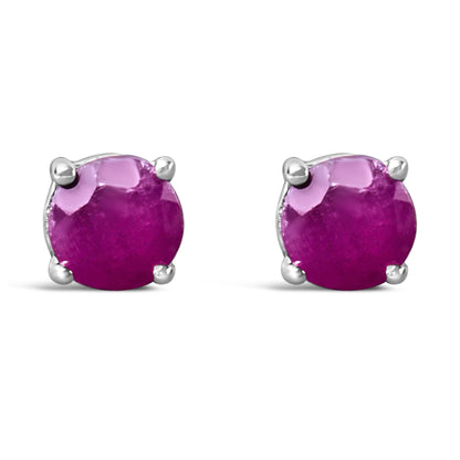 Front view of a pair of white metal stud earrings with round pink gemstones in 4-prong settings.