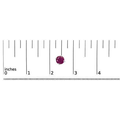 Close-up front view of a single white metal earring with a round pink gemstone in a four-prong setting placed on a ruler for size reference.