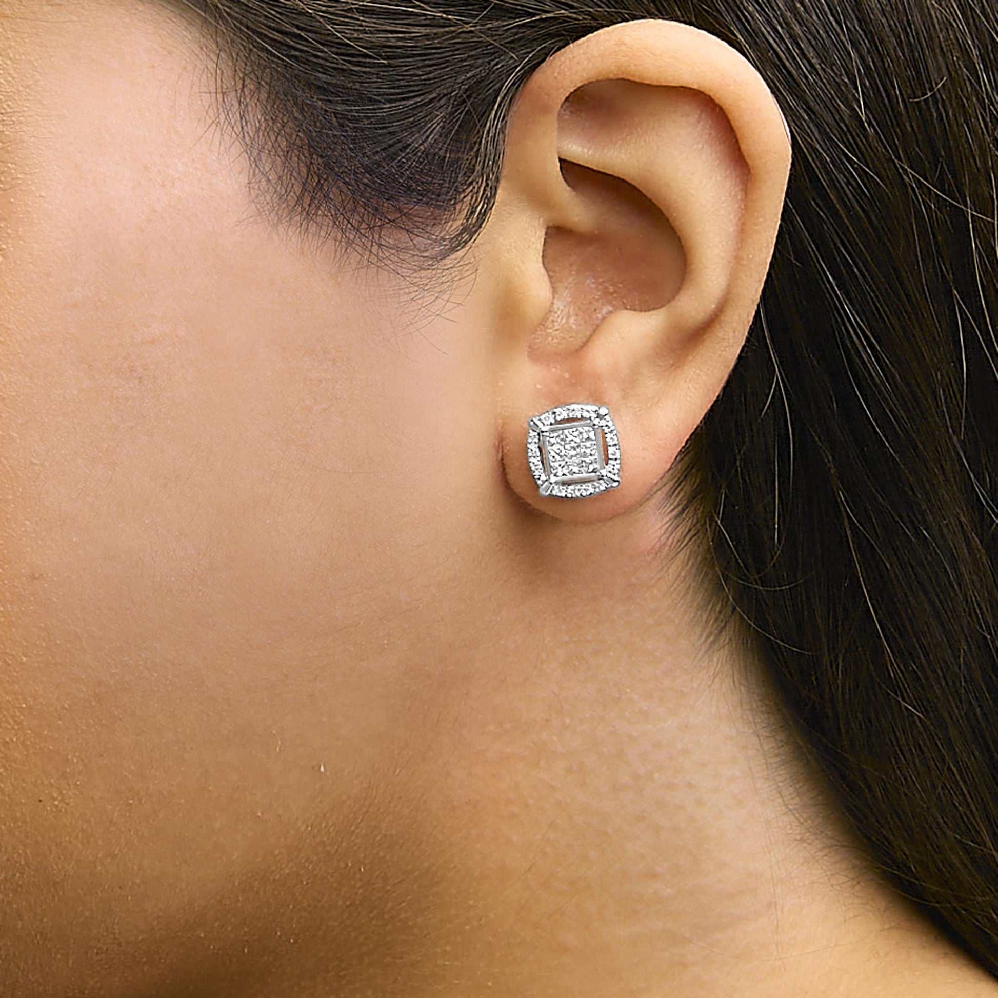 White metal square-shaped earring with princess and round white gemstones, shown worn on a model from a side angle.