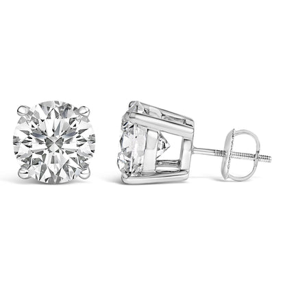 Close-up front and side angle of white metal stud earrings with round white gemstones in 4-prong settings.