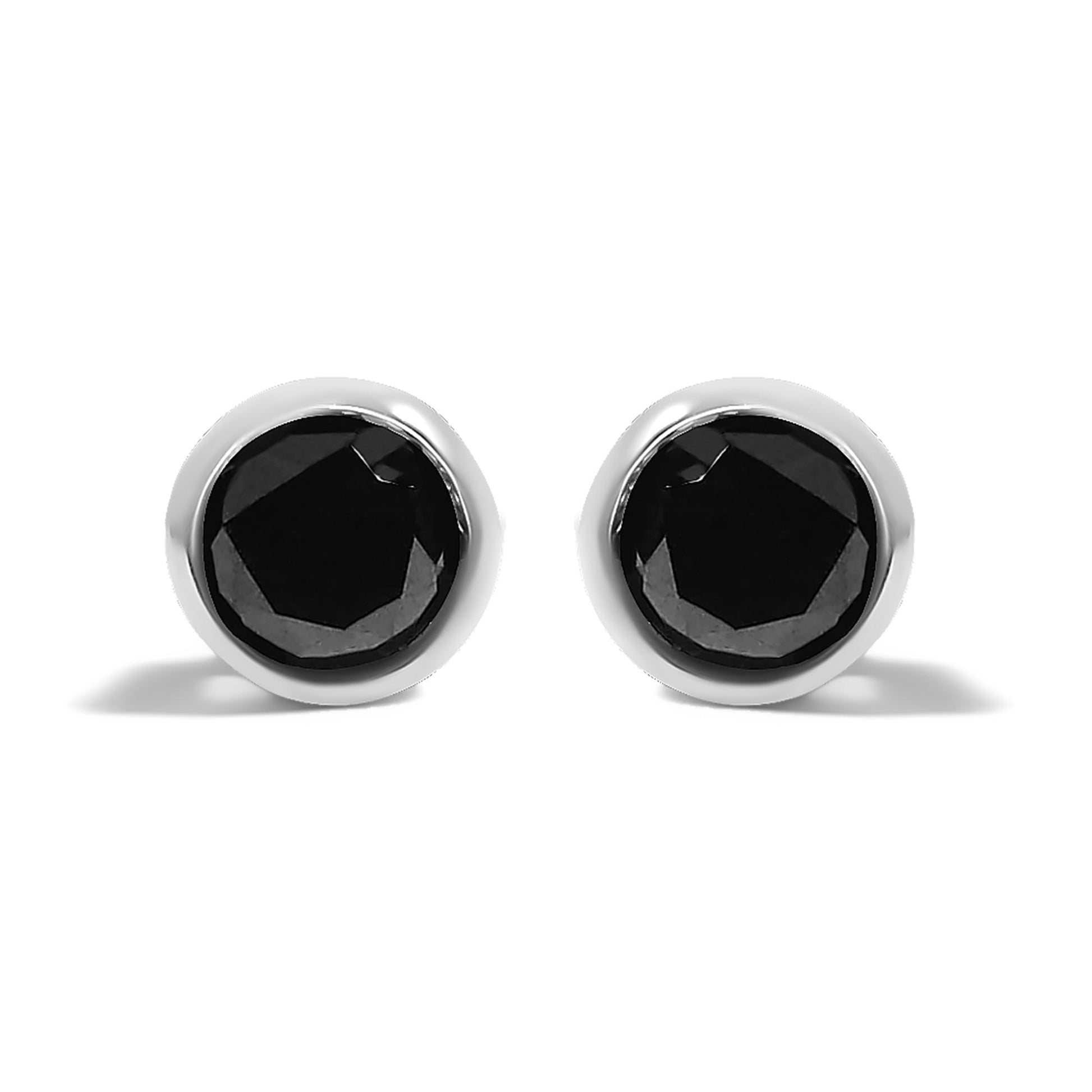 Front angle close-up of a pair of white metal stud earrings, each featuring a single round black gemstone in a bezel setting.