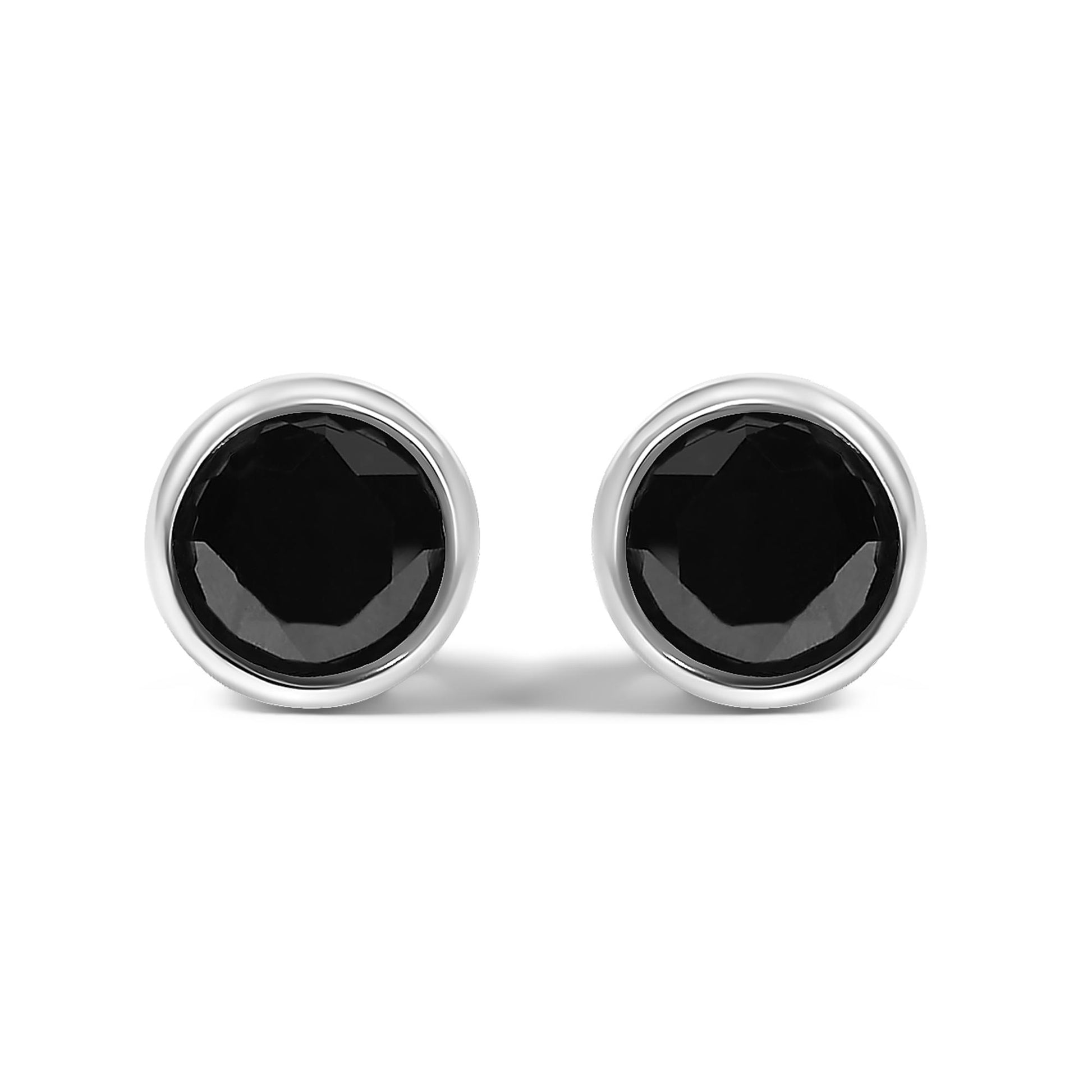 Front view of round bezel-set black gemstone earrings with white metal setting on a white background.