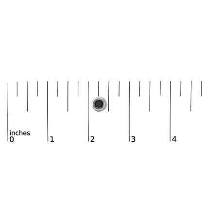 Single white earring with a round black gemstone in a bezel setting, shown on a ruler for scale, photographed from above.
