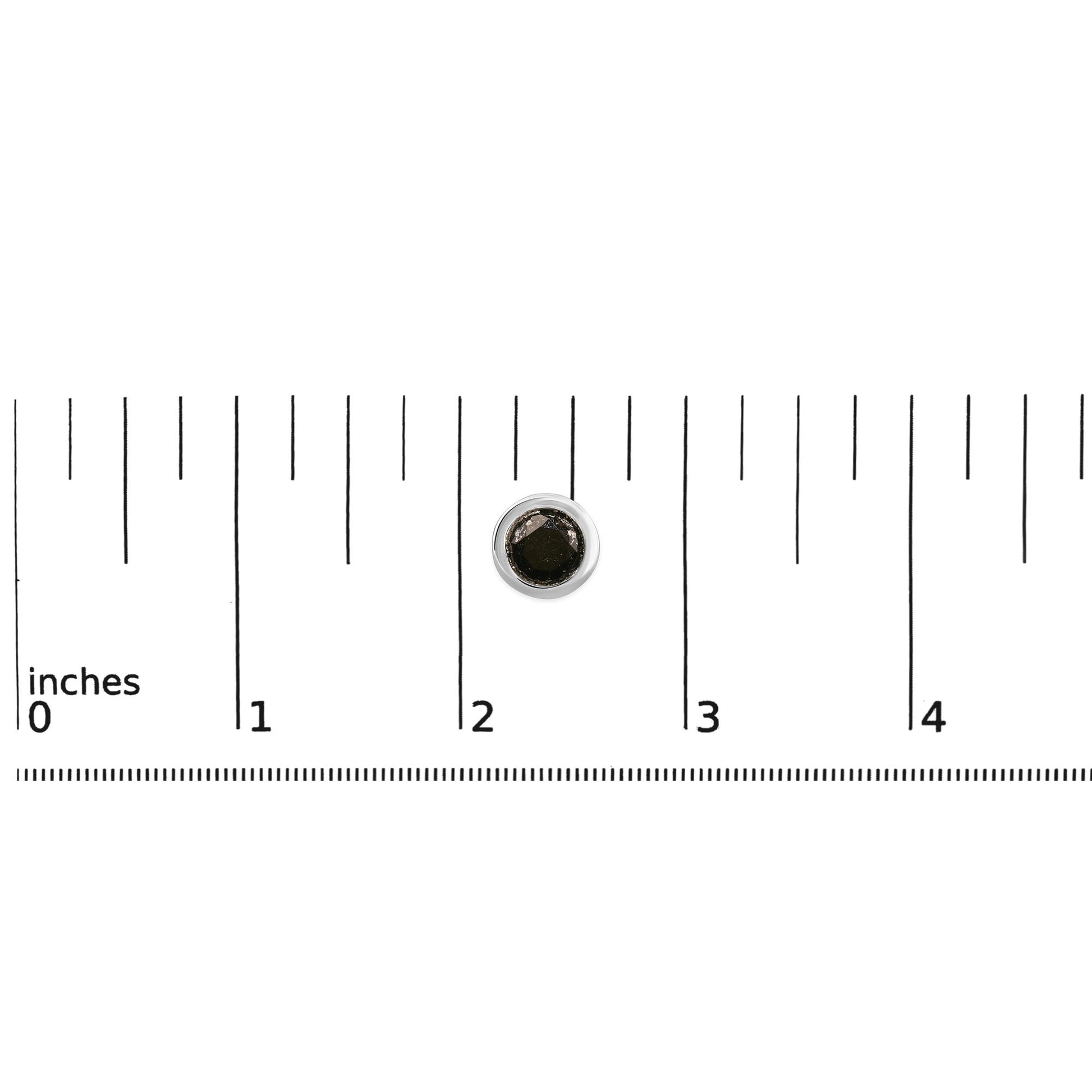 Single white metal round stud earring with a bezel-set black gemstone shown on a measuring scale from above.