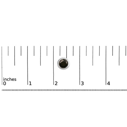 Single white metal round stud earring with a bezel-set black gemstone shown on a measuring scale from above.