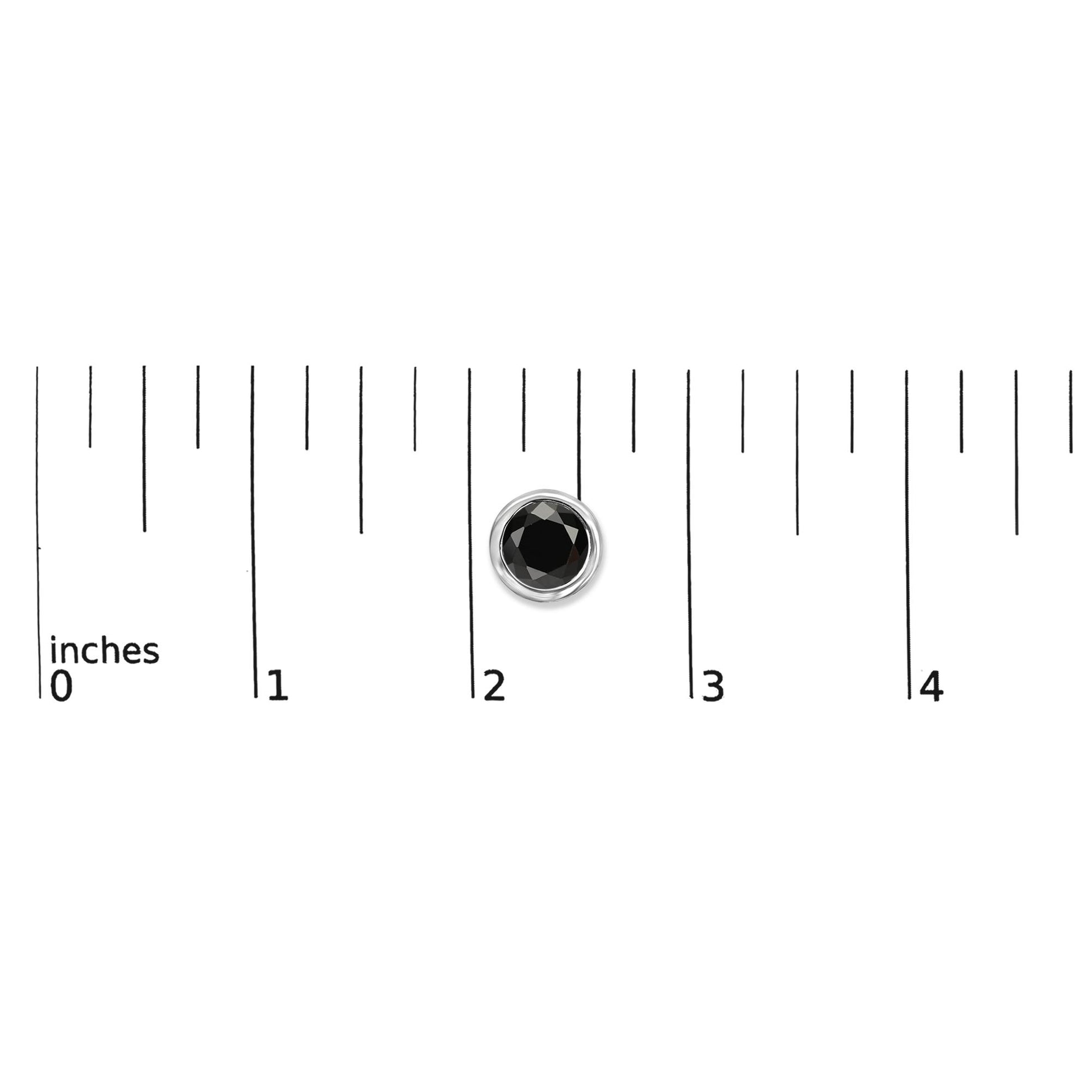 Single white metal earring with a round black gemstone in bezel setting shown on a ruler scale from a top-down angle.