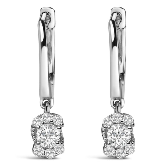 Front-facing close-up of a pair of white metal drop earrings with a central round white gemstone surrounded by multiple smaller round white gemstones, shown on a white background.