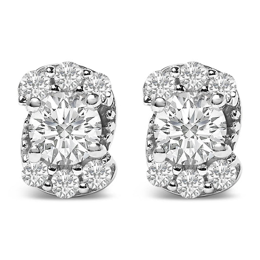 Close-up front view of a pair of white metal stud earrings featuring a large central round white gemstone surrounded by smaller round white gemstones in prong settings.