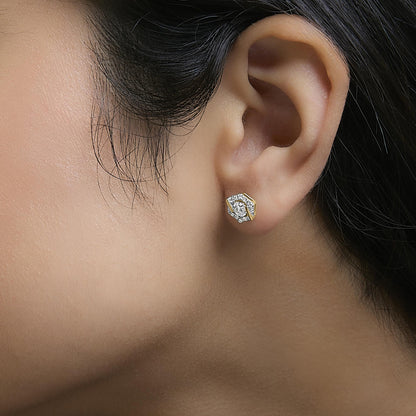 Close-up side view of a model wearing a yellow metal earring with a hexagonal shape, featuring small round white gemstones in prong settings clustered on the front.