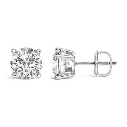 Pair of white metal stud earrings with round white gemstones in 4-prong settings, shown side and front angles on a white background.