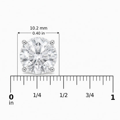 Close-up image of a single white metal round-shaped earring with a white gemstone in a four-prong setting shown on a scale.