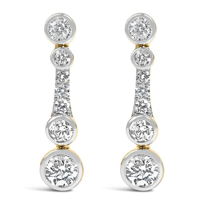 Close-up front view of a pair of yellow metal earrings featuring multiple round white gemstones, some bezel set and others prong set, arranged vertically.