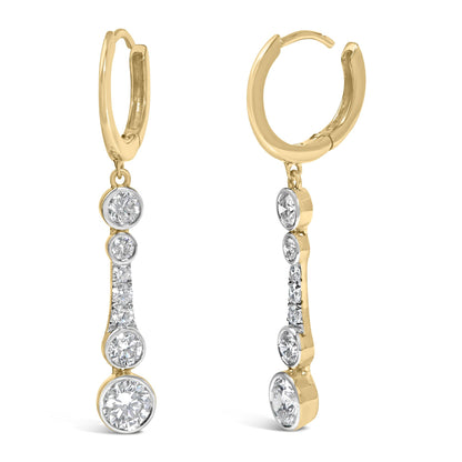 Close-up front angle of yellow metal hoop earrings with multiple round white gemstones in bezel and prong settings, shown without a model or scale.