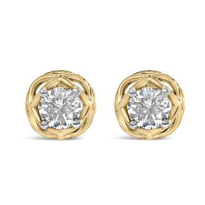 Close-up front view of round white gemstone earrings in a prong setting, surrounded by a yellow metal woven circular design, shown on a white background.