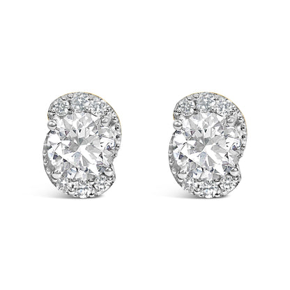 Close-up front view of a pair of yellow metal earrings with large round white gemstone centers surrounded by smaller round white gemstones in prong settings.