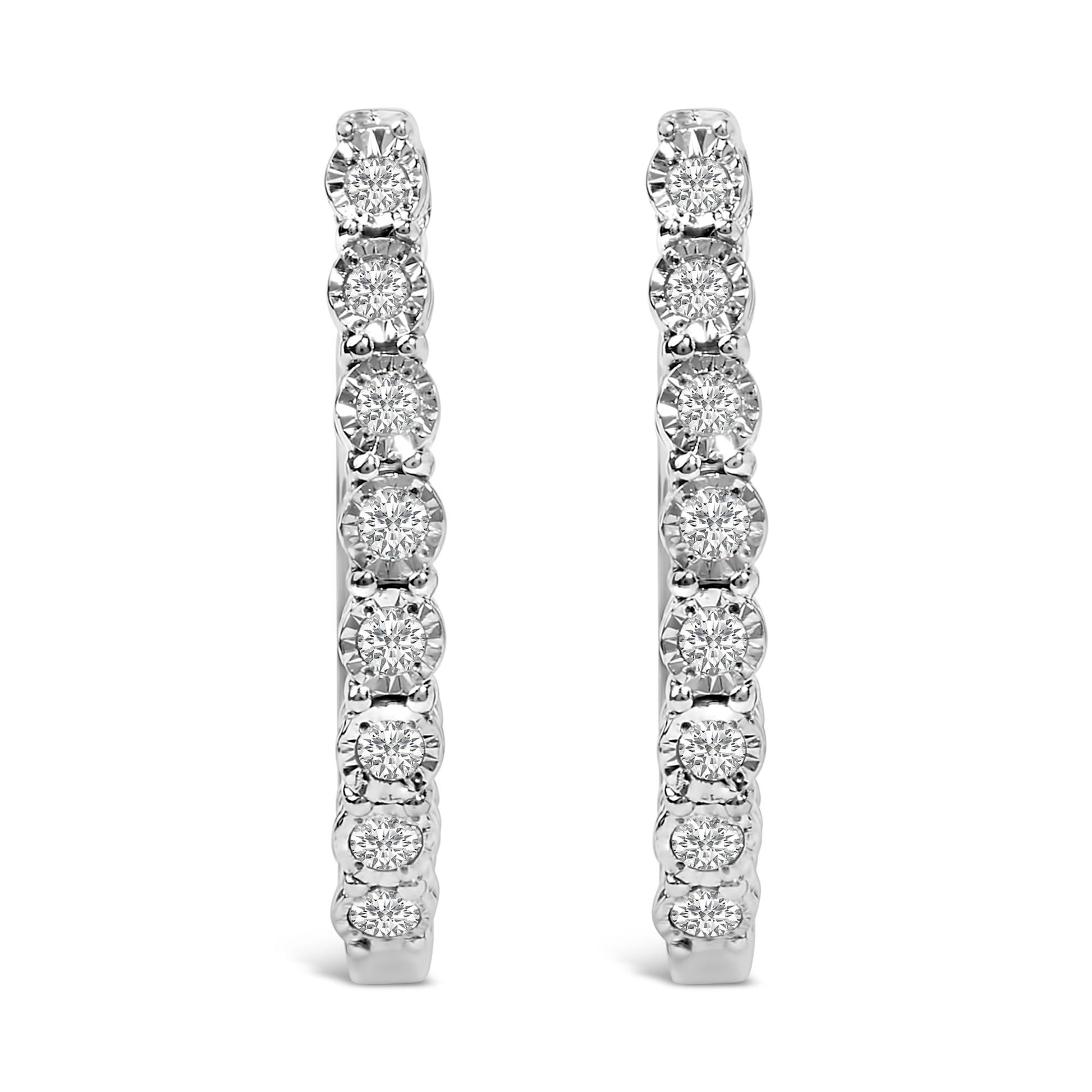 Close-up front view of a pair of white-colored metal hoop earrings featuring round white gemstones set in a miracle setting along the outer edge.