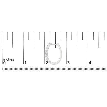 White metal hoop earring with round white gemstones set along one side, shown on a scale from a front angle.