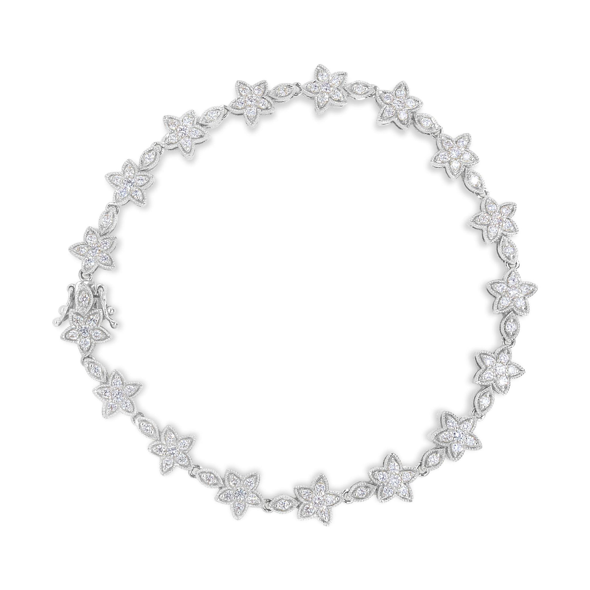 Top-down view of a white metal bracelet featuring alternating flower and marquise-shaped links, each adorned with white round gemstone prong settings.