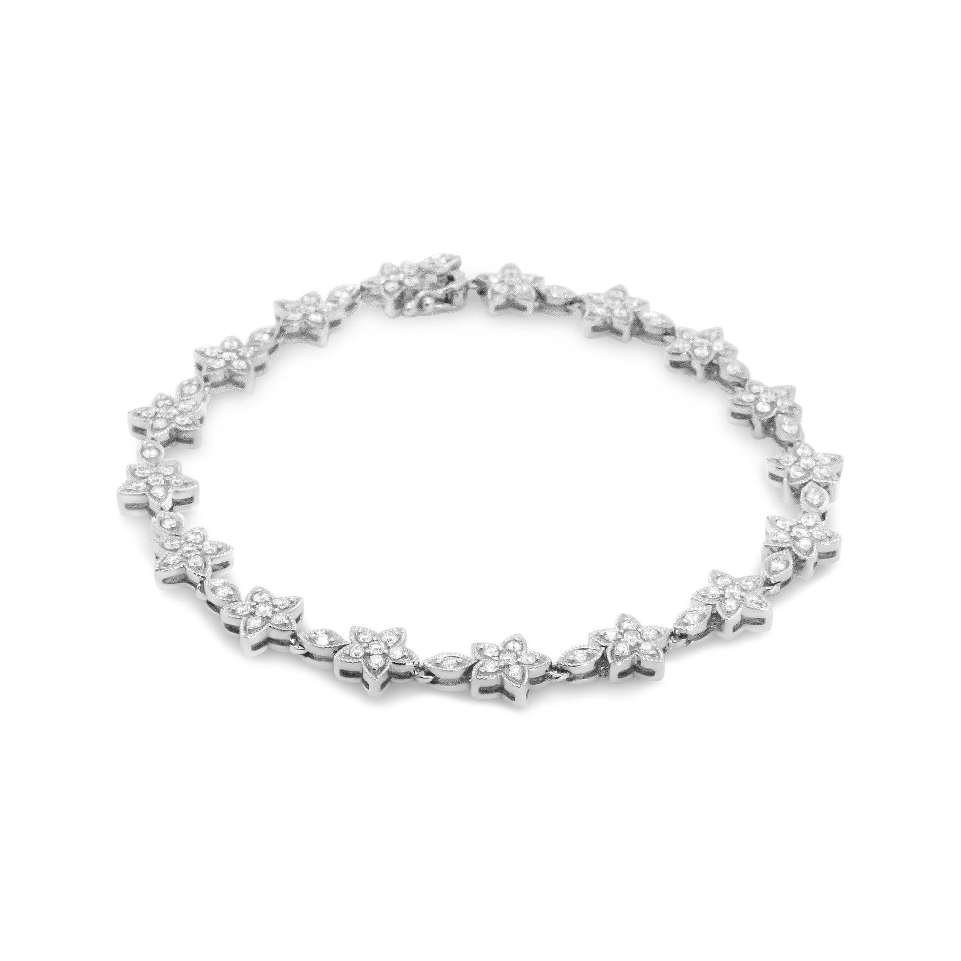 White metal bracelet with flower-shaped links set with round white gemstones, shown from a top angle on a white background.