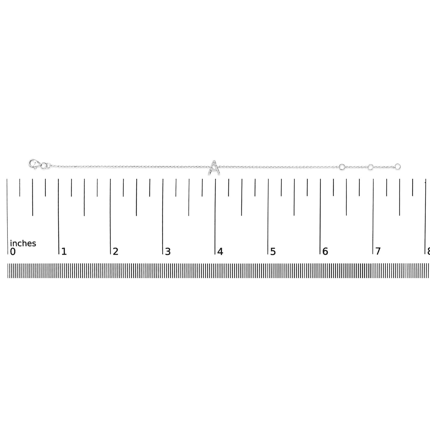 White metal bracelet with a central 'A' charm adorned with small white gemstones in a micro-pave setting, shown laid flat on a ruler for scale, image taken from a top-down angle.