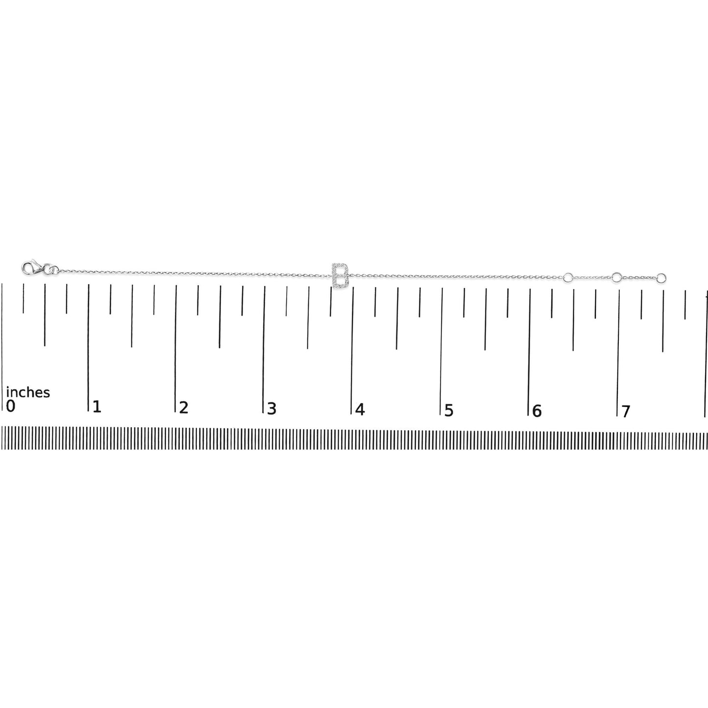 White metal bracelet with a letter-shaped charm set with white round gemstones in micro-pave setting, shown flat on a ruler scale from a top-down angle.