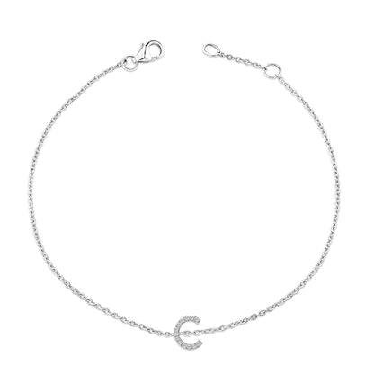 Top-down view of a white metal bracelet with a delicate chain and a small C-shaped charm set with round white gemstones in a micro-pave setting.