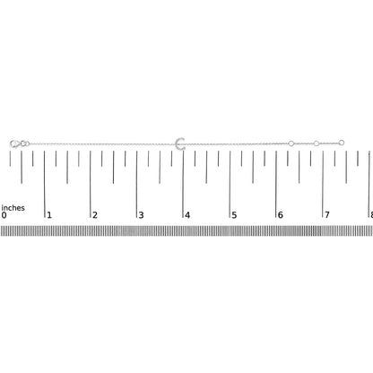White bracelet with a crescent-shaped centerpiece set with small white gemstones, shown on a horizontal ruler scale, front-facing angle.