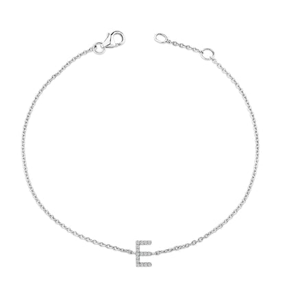 White bracelet with a delicate chain and a letter 'E' charm featuring white round gemstones in a micro-pave setting, shown from a top-down angle on a white background.