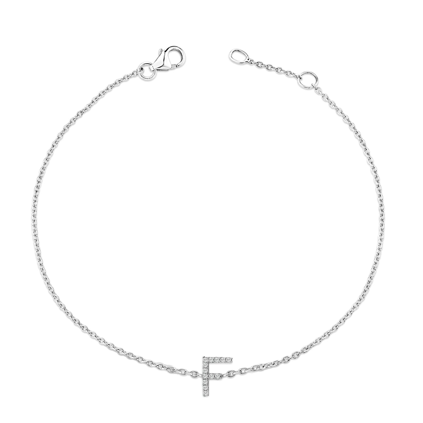 White metal bracelet with a chain and a letter 'F' charm adorned with white round gemstones in a micro-pave setting, shown from a top-down angle on a white background.
