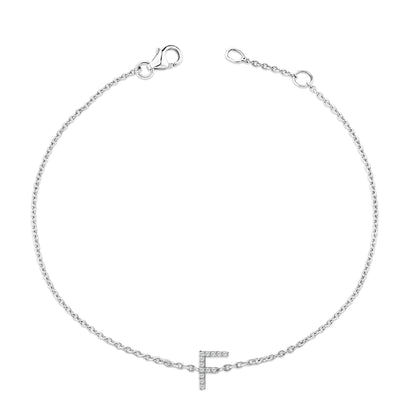 White metal bracelet with a chain and a letter 'F' charm adorned with white round gemstones in a micro-pave setting, shown from a top-down angle on a white background.