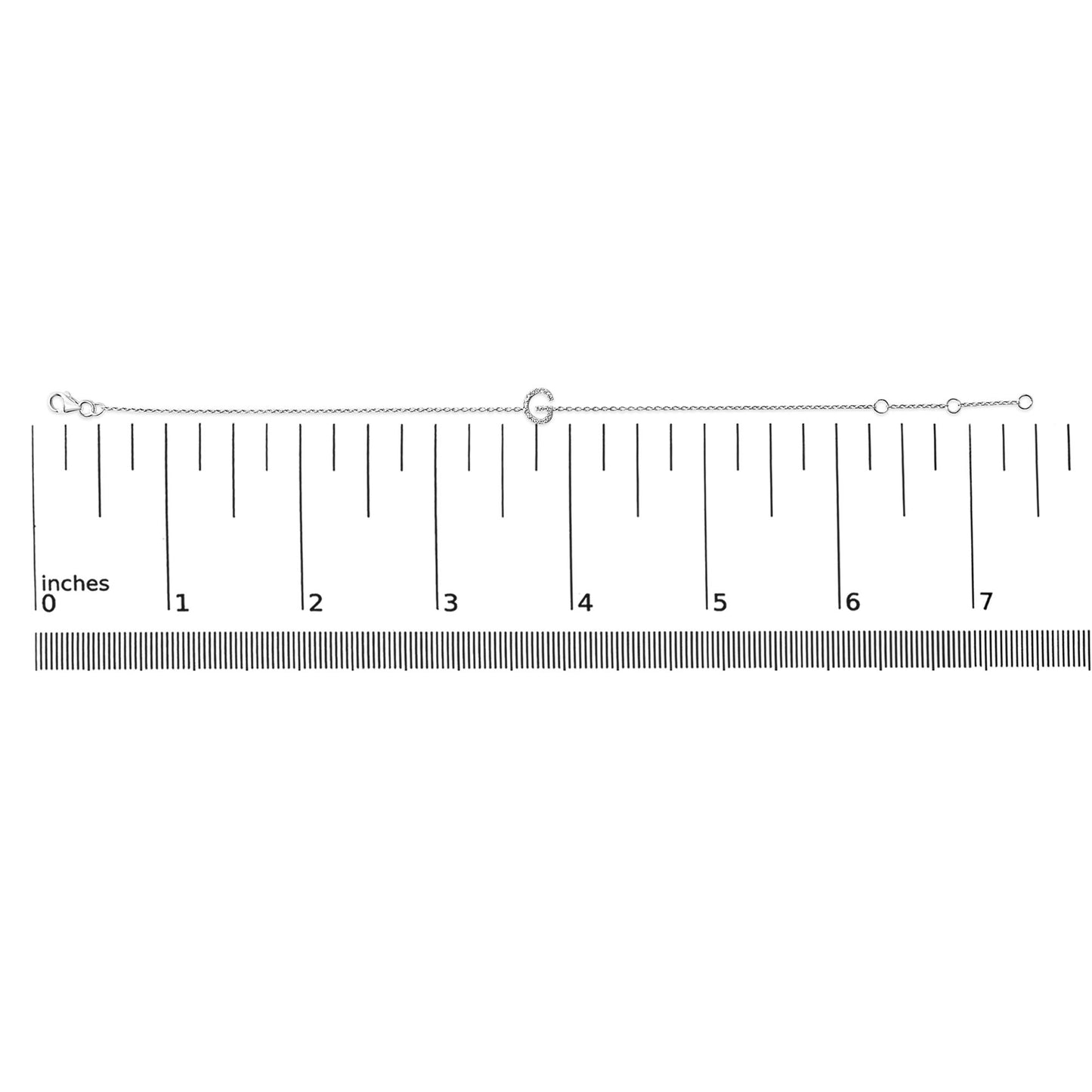 White bracelet with a micro-pave set round white gemstones forming a letter shape, shown flat on a ruler for scale, top-down angle.