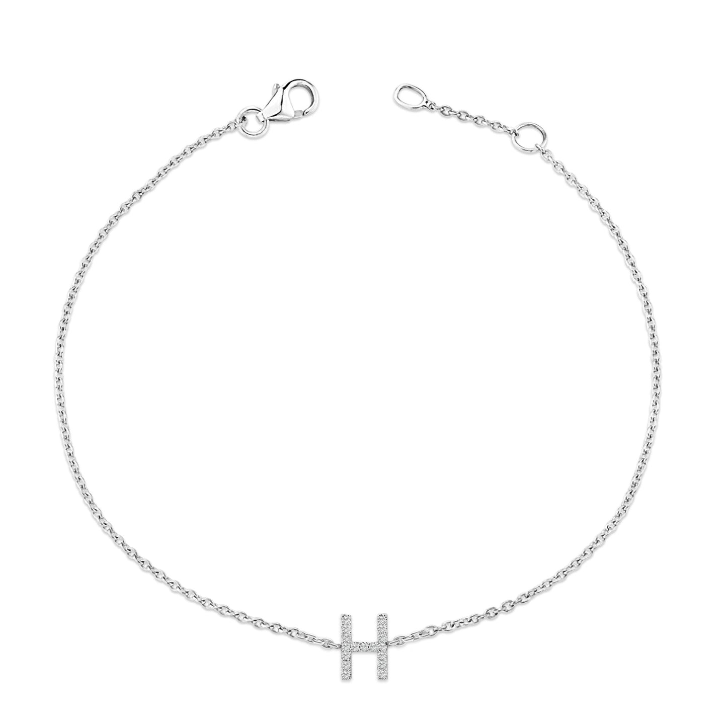 White metal bracelet with a chain and a central 'H' shaped charm adorned with small white gemstones, shown from a top flat lay angle.