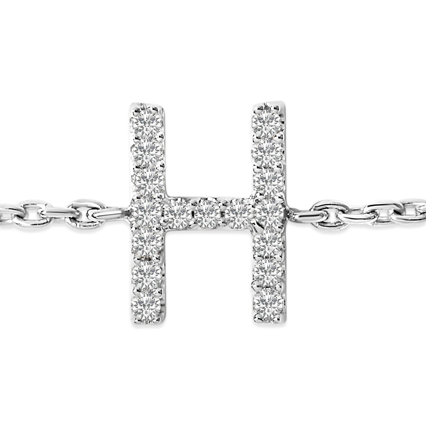 Close-up front view of a white metal bracelet featuring a horizontal H-shaped centerpiece adorned with round white gemstones in a micro-pave setting, shown on a white background.