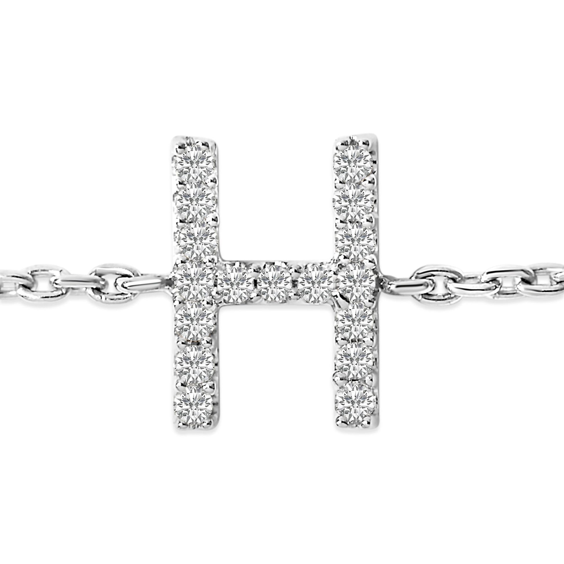 Close-up front view of a white metal bracelet featuring a horizontal H-shaped centerpiece adorned with round white gemstones in a micro-pave setting, shown on a white background.