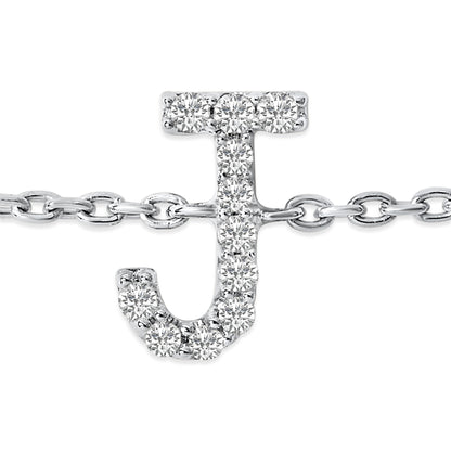 Close-up front view of a white metal bracelet featuring a 'J' shaped charm adorned with round white gemstones in a micro-pave setting, displayed on a white background.