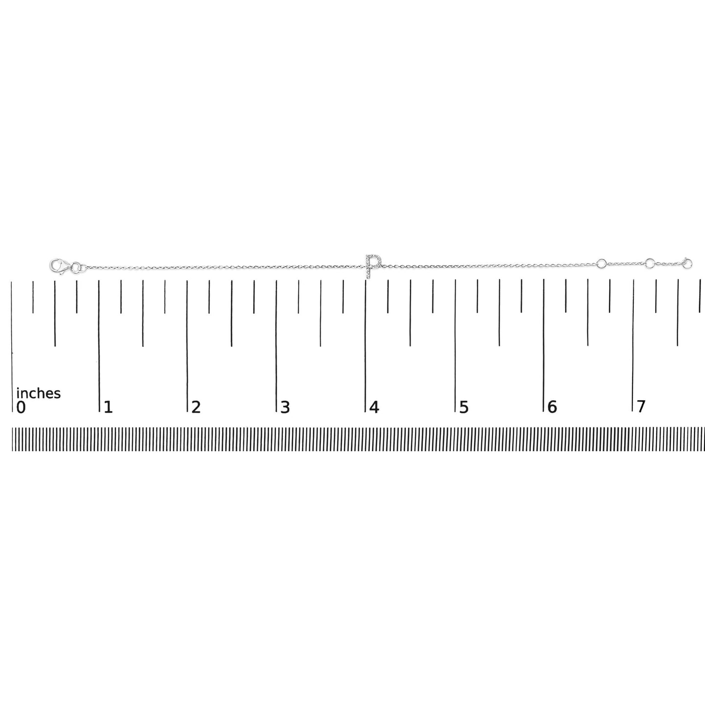 White metal bracelet with a letter-shaped charm featuring small white gemstones in a micro-pave setting, shown flat on a ruler scale with a top-down angle.