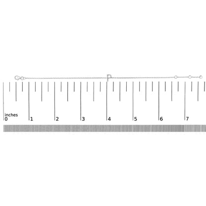 White metal bracelet with a letter-shaped charm featuring small white gemstones in a micro-pave setting, shown flat on a ruler scale with a top-down angle.