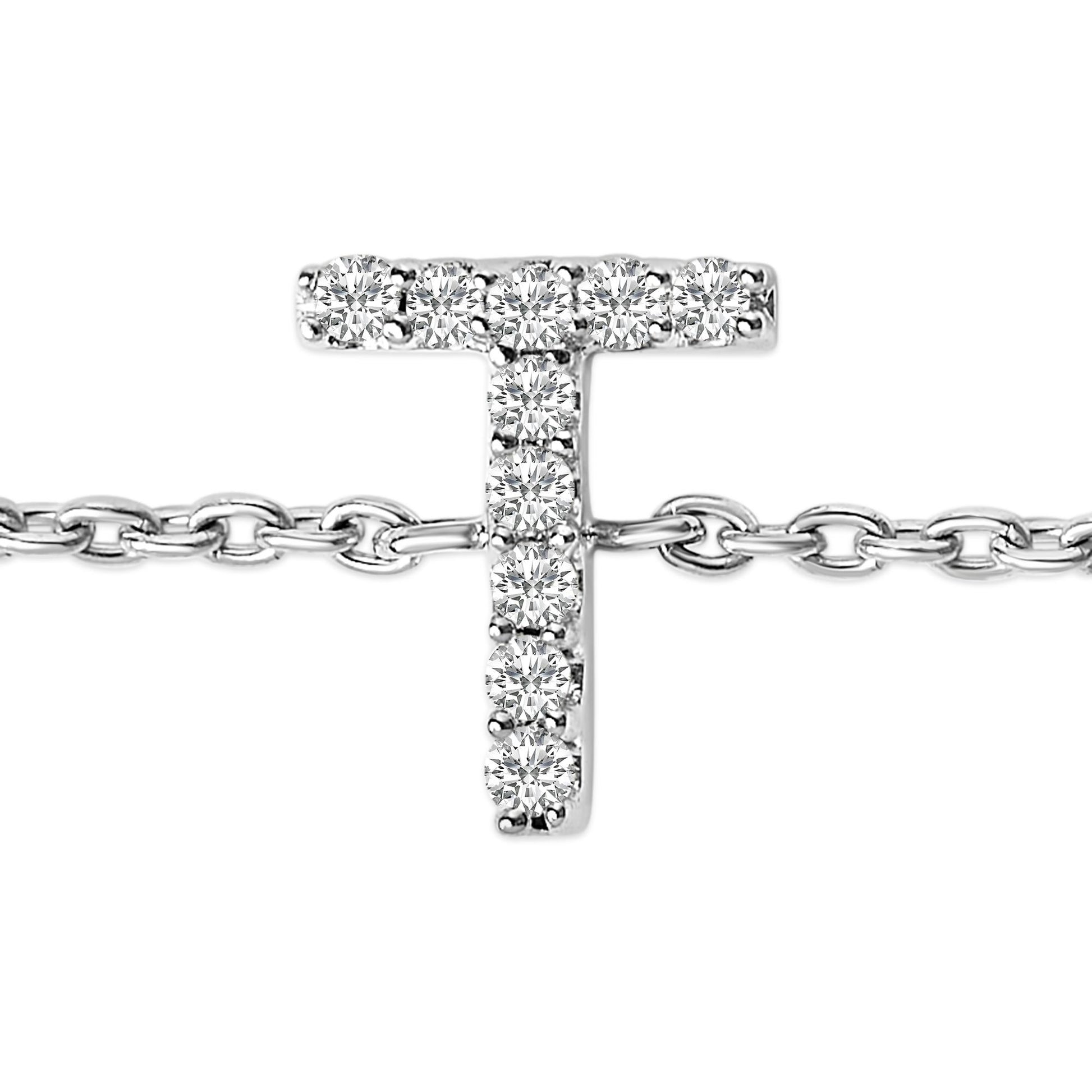 Close-up front view of a white metal bracelet featuring a T-shaped centerpiece adorned with round white gemstones in a micro-pave setting, shown on a white background.